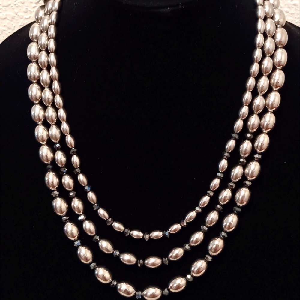 Carol Dauplaise Three strand silver metallic & black glass bead necklace.